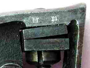 "M M" STAMPING - LEFT REAR FRAME UNDER GRIP